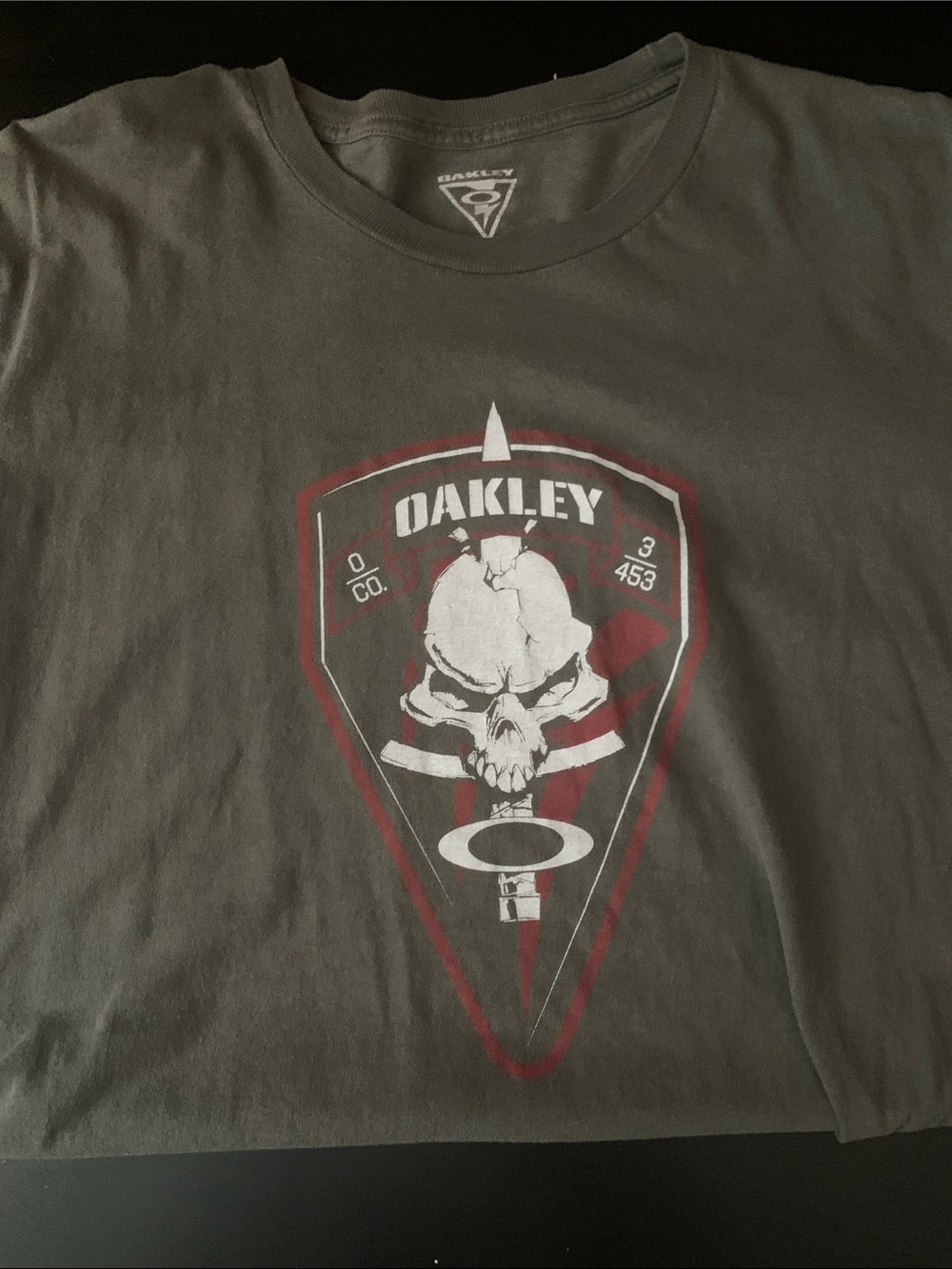 Oakley Olive Tee with Skull Shield Graphic and Red Accents
